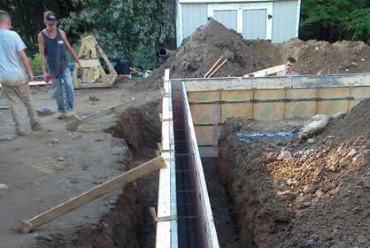 Worker hands installing bitumen roof shingles
